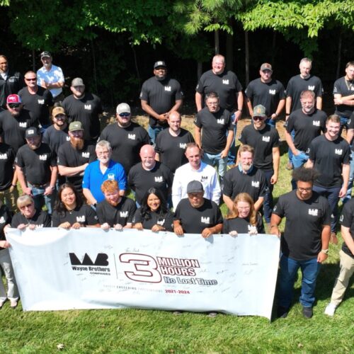 Group in black shirts holds banner: “3 Million Hours No Lost Time.”