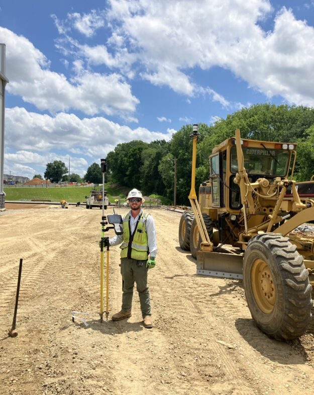 Surveyor poses with tripod