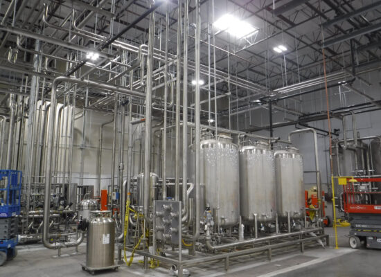 Industrial building filled with tanks and piping systems