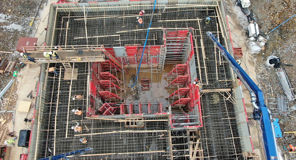 Aerial view of workers assembling formwork and rebar onsite.