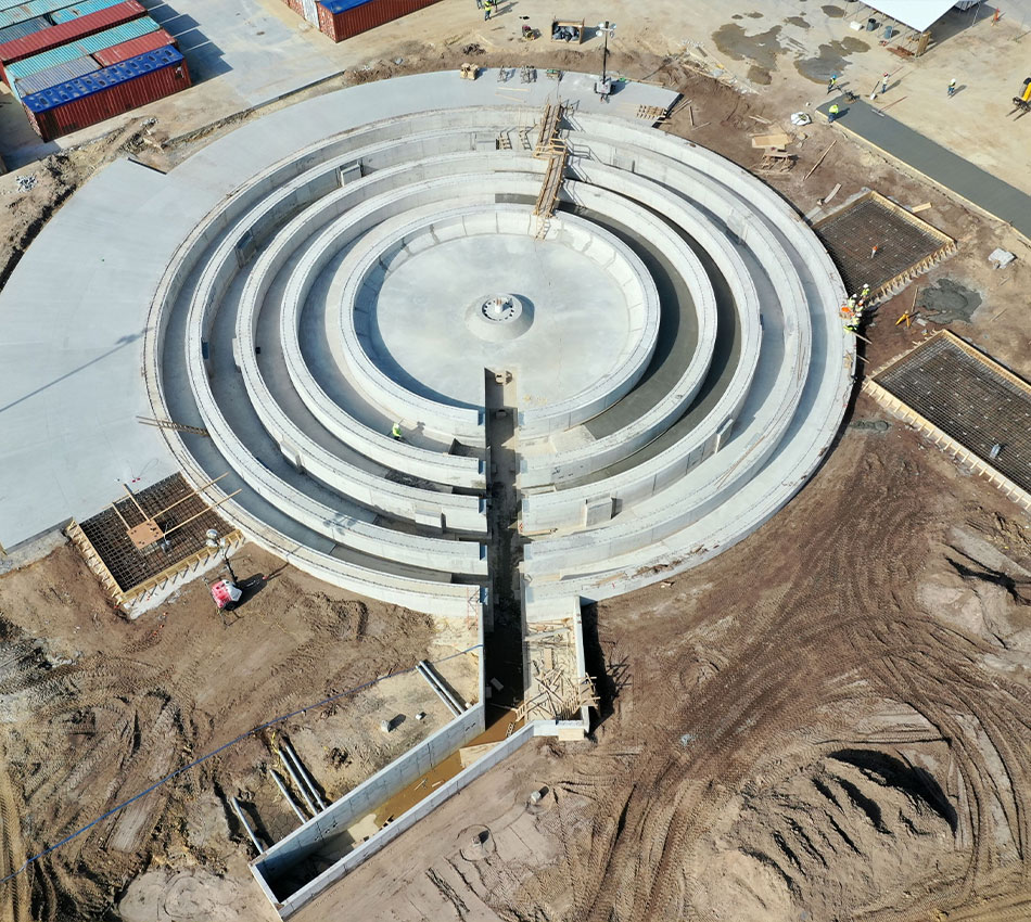 Aerial view of circular concrete structure under construction.