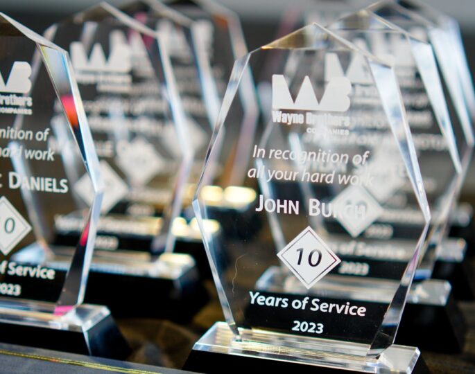 Glass plaques engraved with 2023 Years of Service awards.