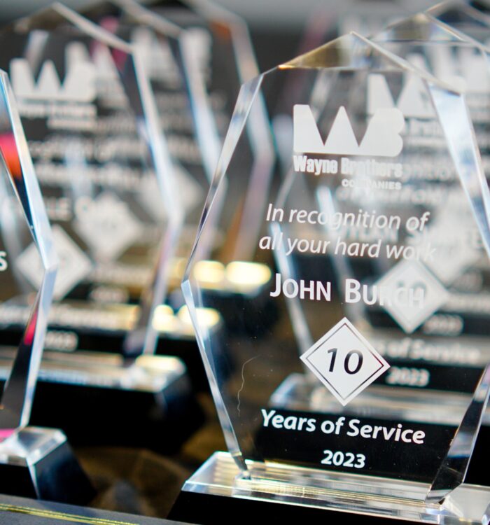 Glass plaques engraved with 2023 Years of Service awards.