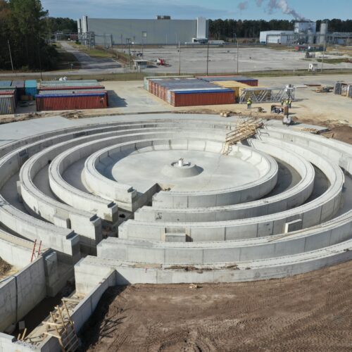Aerial view of circular concrete structure under construction.