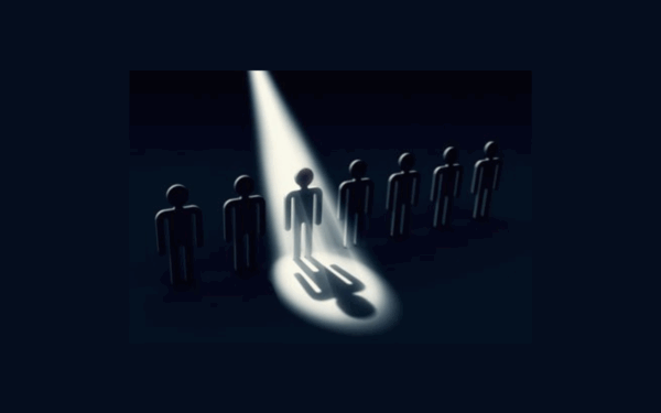 Six figures in a row, spotlight on the center figure.